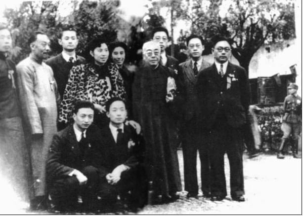 black and white image of ten men and women posing for a photo at a conference