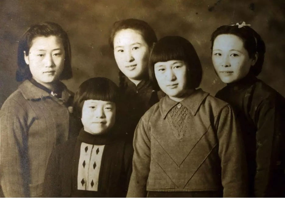 black and white photograph of Zhu Ti and her family. Pictured are five individuals standing next to one another