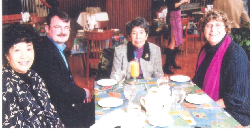 image of four individuals posing at a restaurant