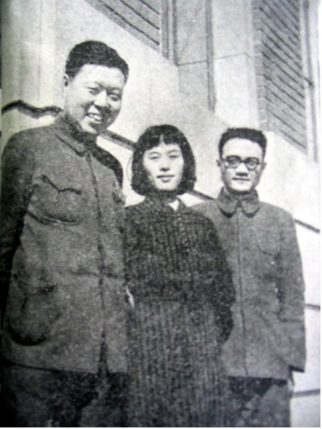 black and white image of a young Wang Lu smiling with Wu Ying and another man