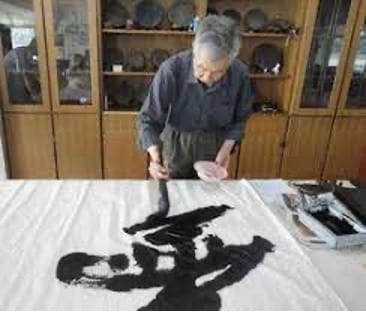 Li Zhengzhong holds a brush, practicing Chinese calligraphy