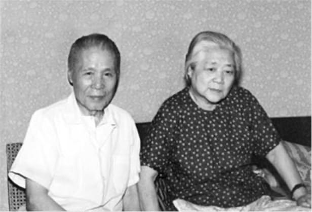 black and white photograph of an elderly man and woman sitting on a couch