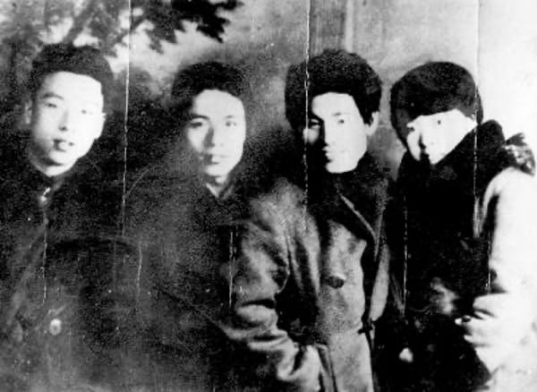 black and white photograph of Shan Ding, Luo Feng, Xiao Jun, and Xiao Hong standing beside one another