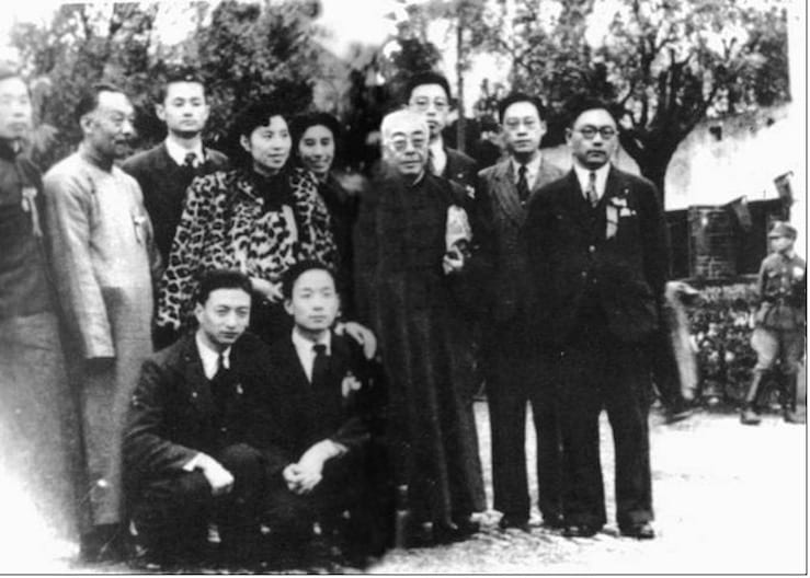 Black and white photograph of a group of men and women