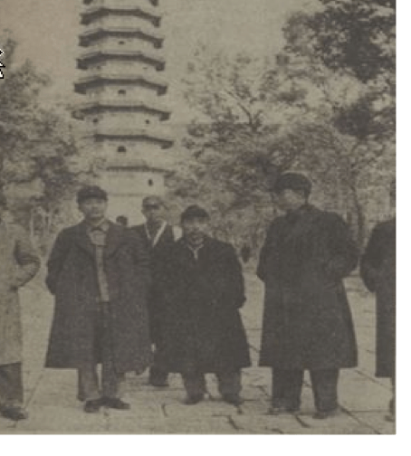 black and white photograph of Gu Ding, Yamada Seizaburō, and Jue Qing standing next to one another in front of a building at a writers' congress