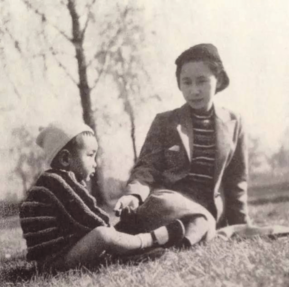 photo of a young Ushijima Haruko with her young son sitting on the grass