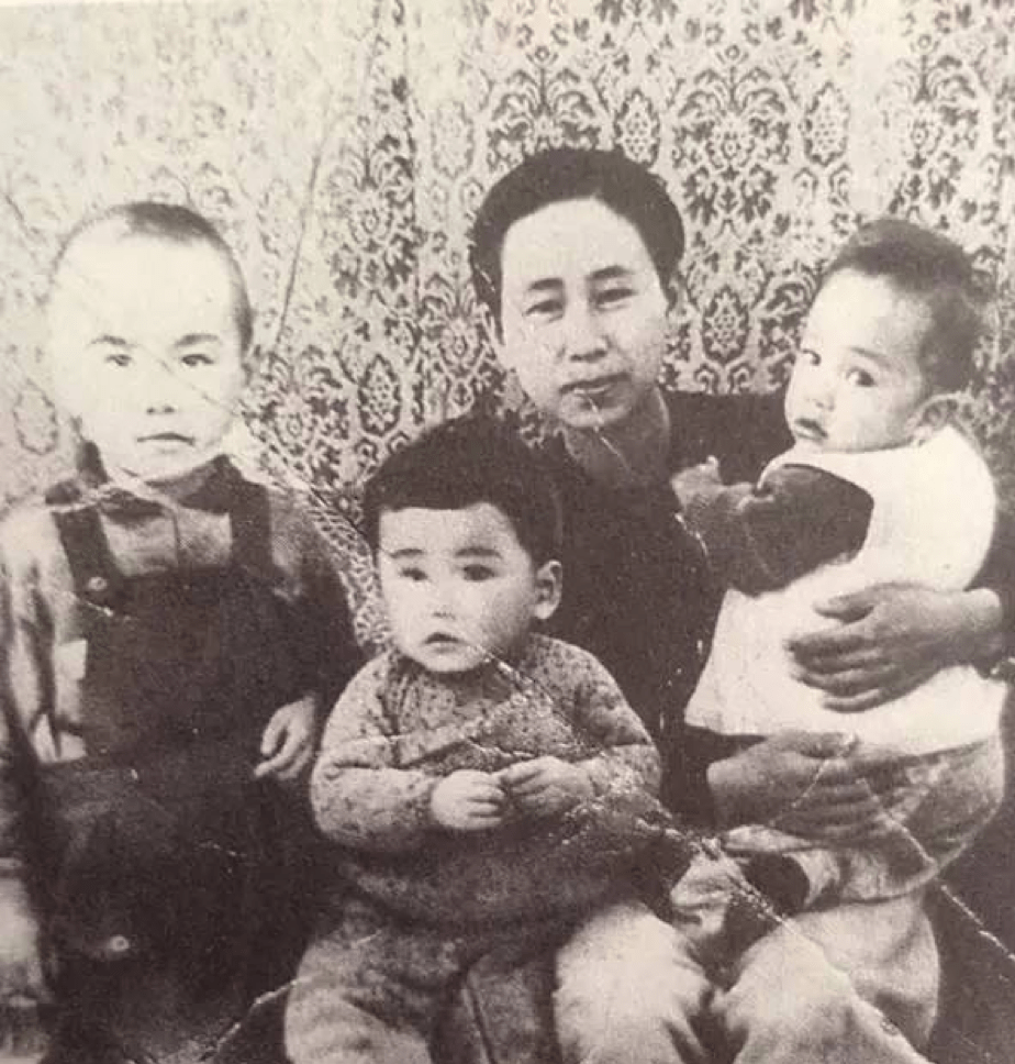 black and white photo of Ushijima Haruko with her three young children