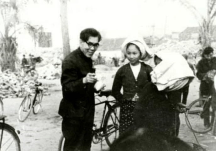 black and white photograph of a man with glasses and two young girls