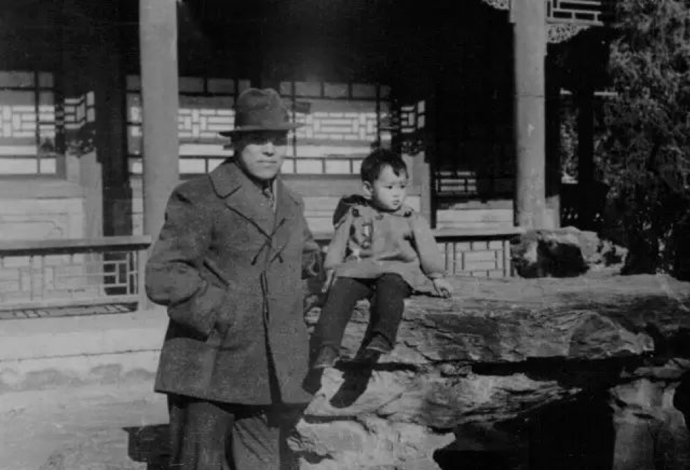 black and white photograph of a man and his young daughter posing outside