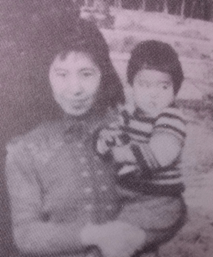 photograph of a woman holding a young child