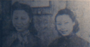 black and white photograph of a young Yang Xu and Zheng Xiaojun smiling