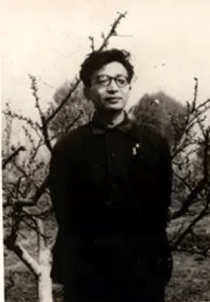 black and white photograph of a younger Yuan Xi's posing outside in front of trees