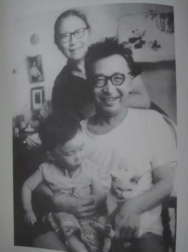 black and white photograph of Yuan Xi and his wife Yao Jin, holding the son of a friend