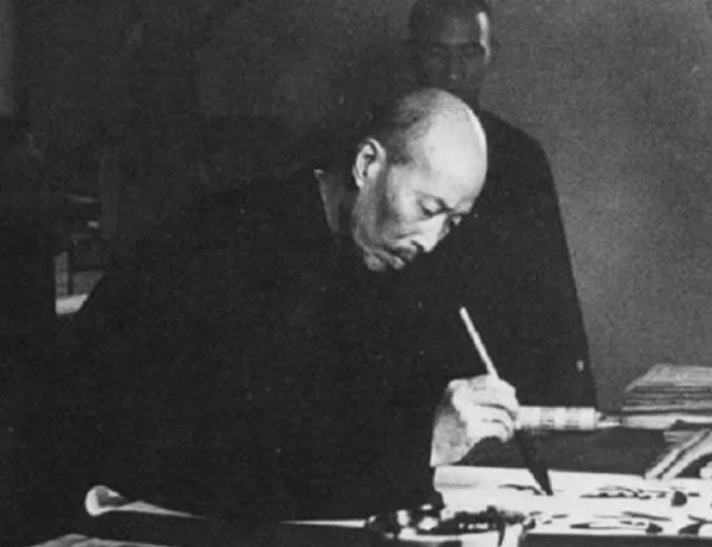 black and white photograph of Zheng Xiaoxu doing calligraphy