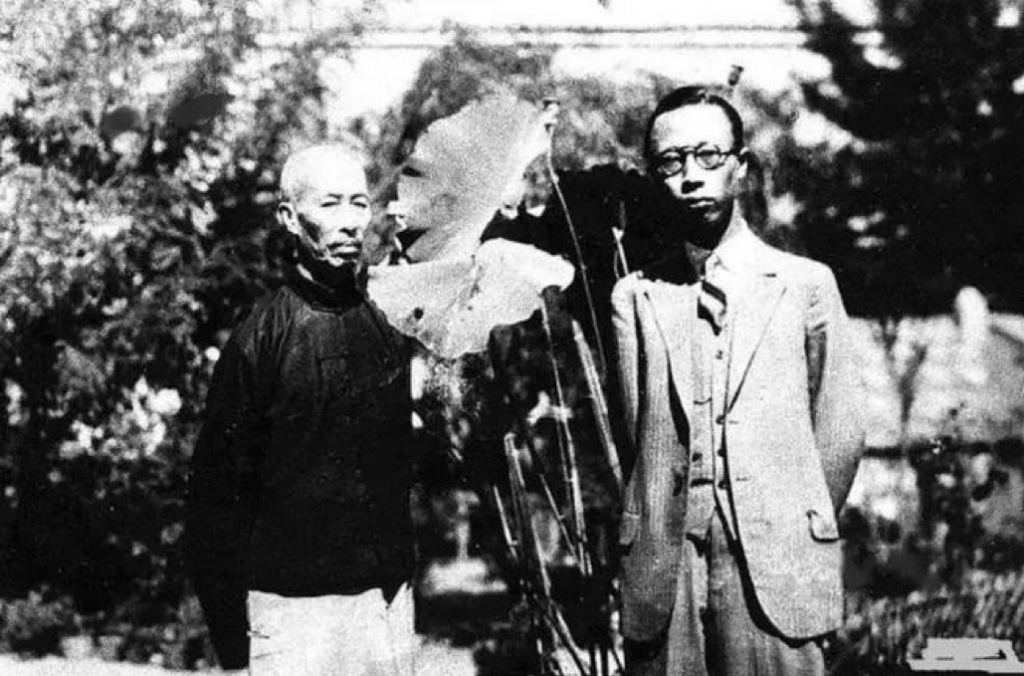 black and white photograph of Zheng Xiaoxu and Puyi standing outside next to trees and plants