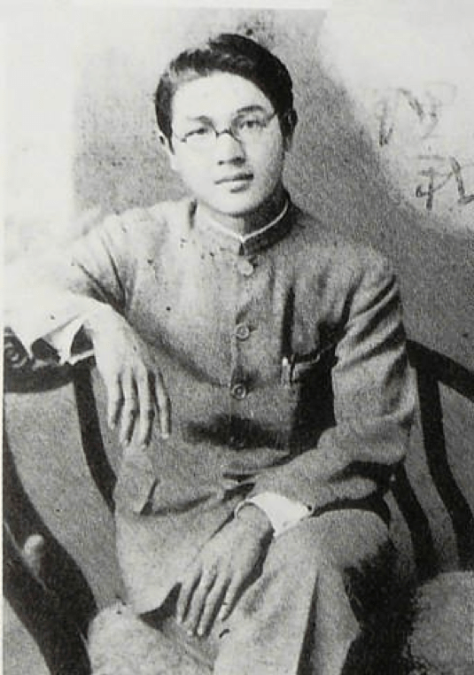black and white photograph of a young Zhong Lihe sitting in a chair