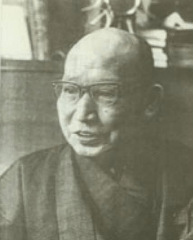 black and white photo of a man with glasses 